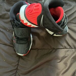 Kyrie Irving’s Black and Red Nike athletic shoe